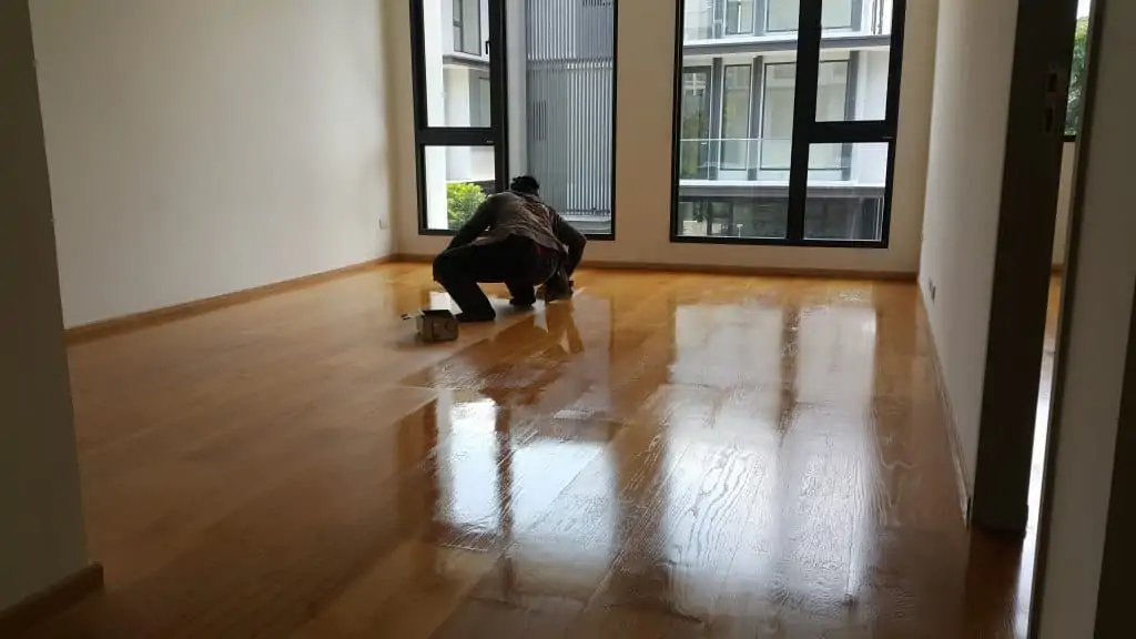 Polyurethane finish being applied to a wood floor.