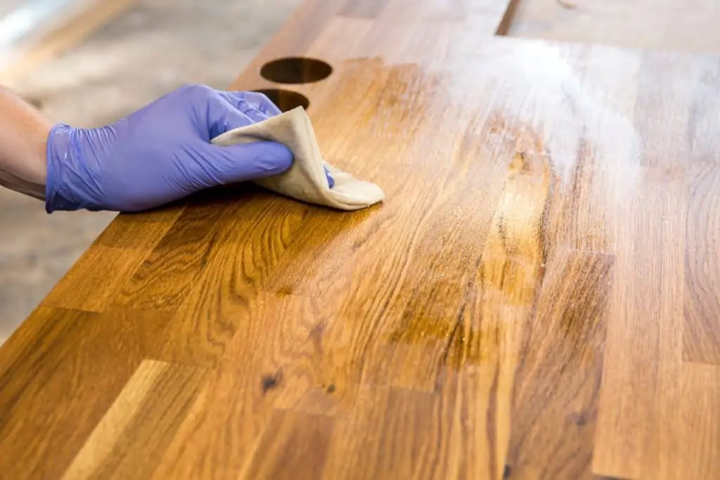 Rubbing a penetrating oil into the wood surface.